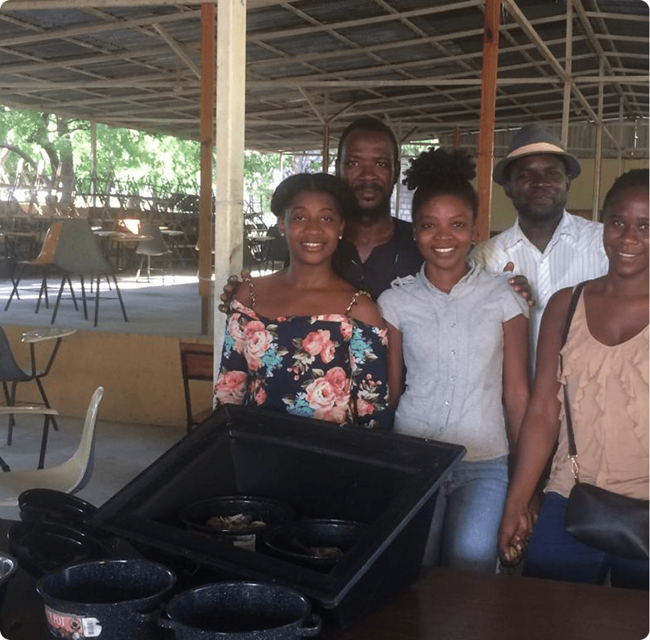 Group of people smiling in a workshop.